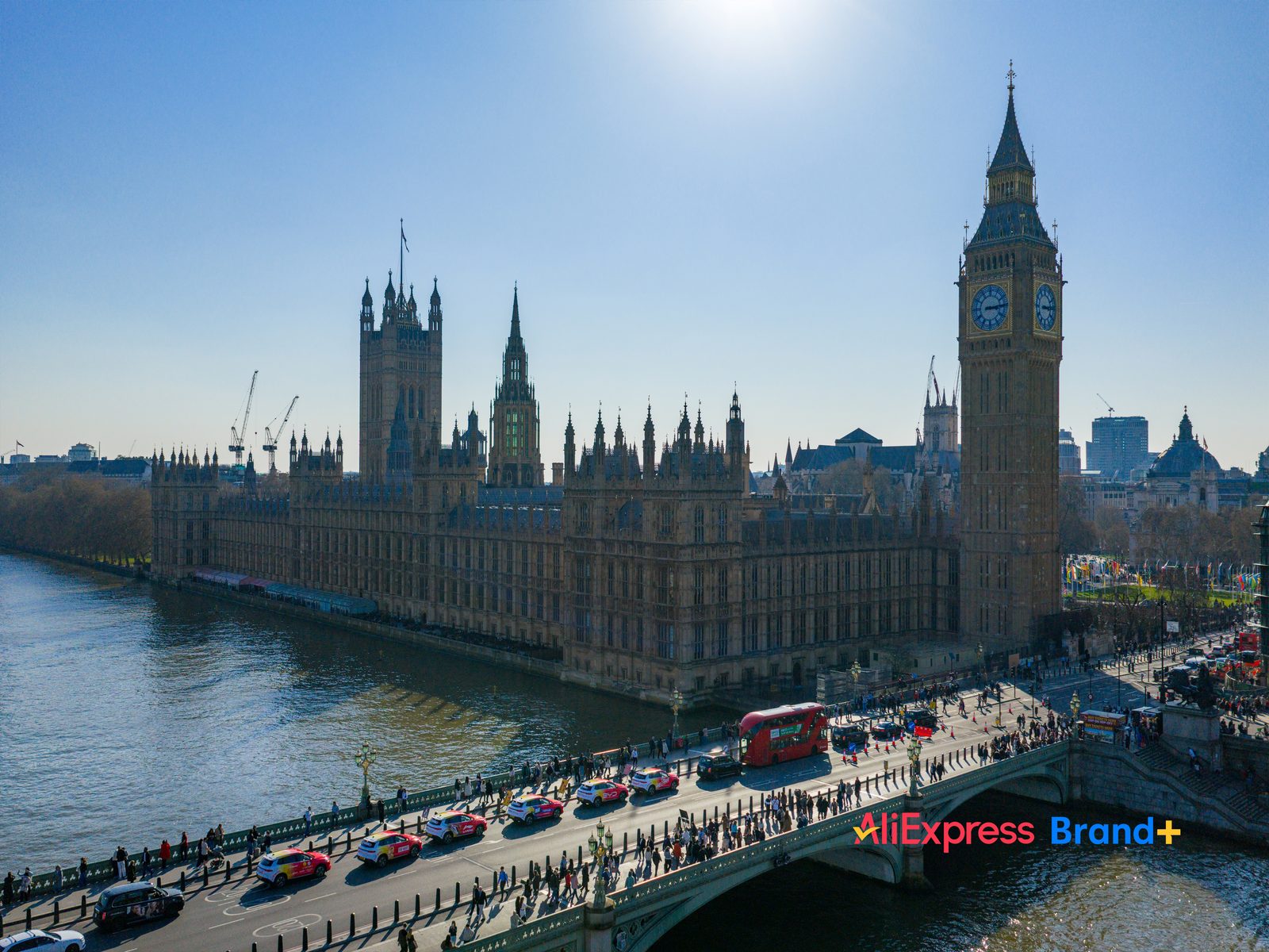 Aerial view of branded fleet crossing Westminster Bridge